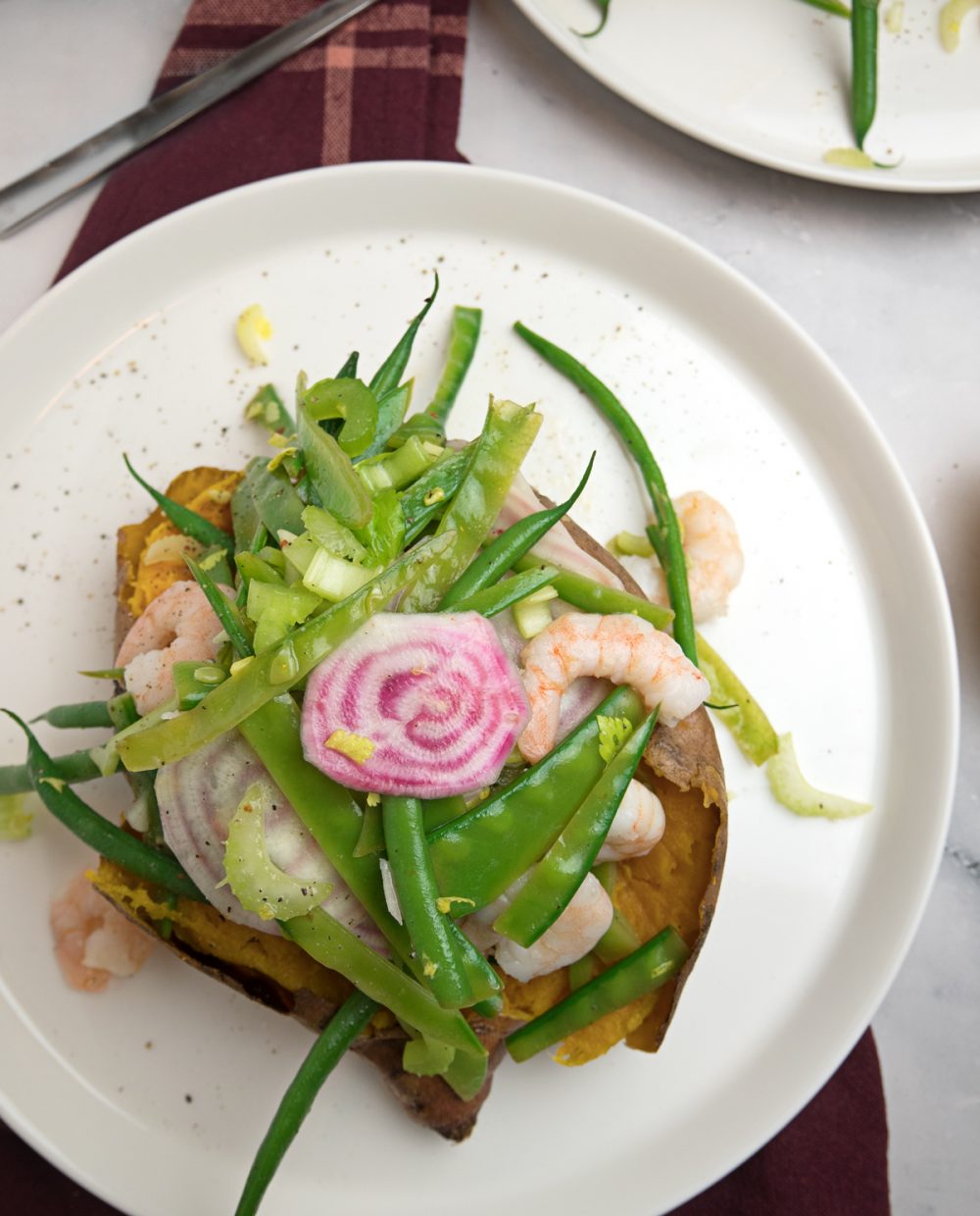 Healthy green bean salad with shrimps on roasted sweet potato