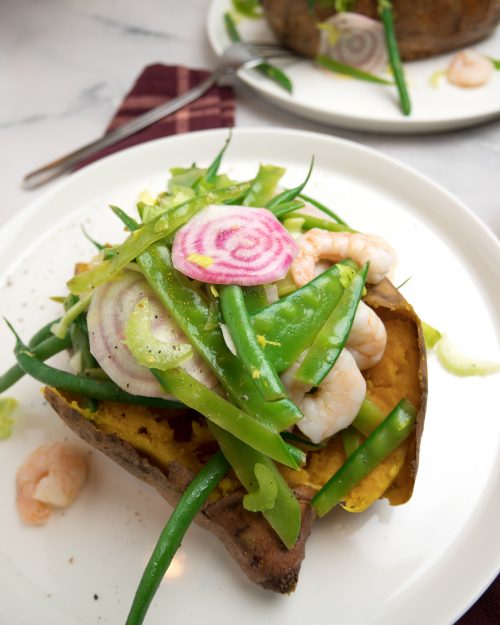 Healthy green bean salad with shrimps on roasted sweet potato
